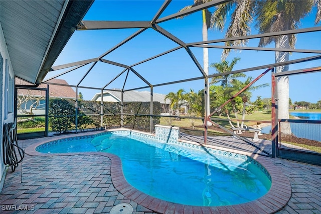 view of pool with a patio and glass enclosure