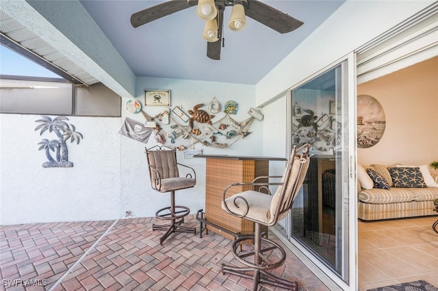 interior space with ceiling fan