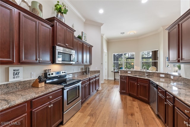 kitchen featuring stone counters, sink, stainless steel appliances, crown molding, and light hardwood / wood-style flooring