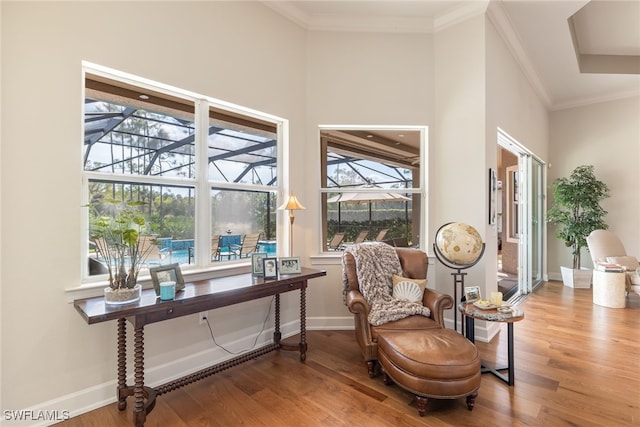 sitting room featuring hardwood / wood-style flooring and crown molding