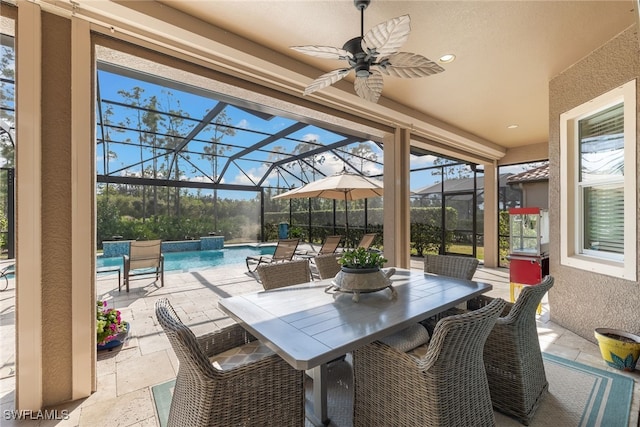 view of patio / terrace featuring a lanai, pool water feature, and ceiling fan