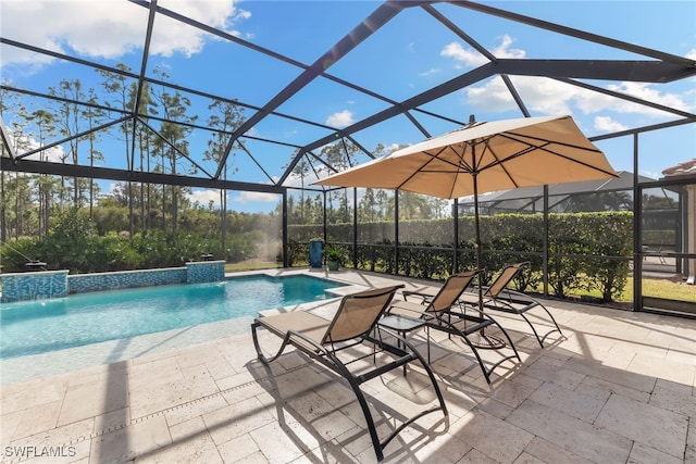 view of pool with a lanai, pool water feature, and a patio area