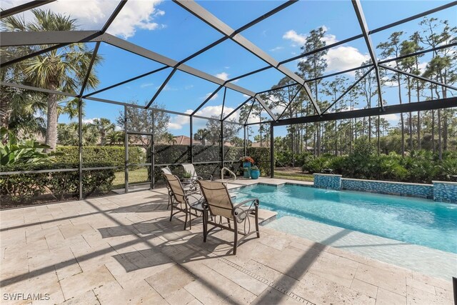 view of swimming pool with pool water feature, a lanai, and a patio