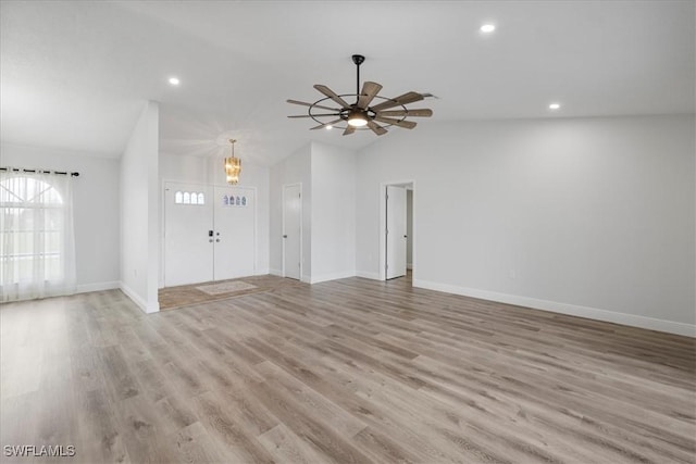 unfurnished living room featuring lofted ceiling, light wood-style floors, baseboards, and recessed lighting