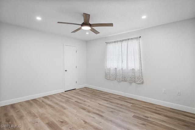 empty room featuring recessed lighting, light wood-style flooring, and baseboards