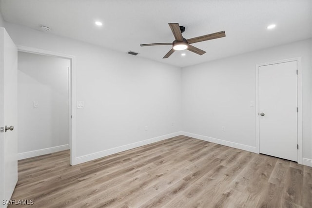 unfurnished room featuring light wood-style floors, recessed lighting, visible vents, and baseboards