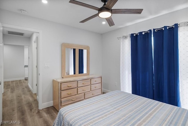 bedroom featuring recessed lighting, visible vents, light wood-style flooring, and baseboards