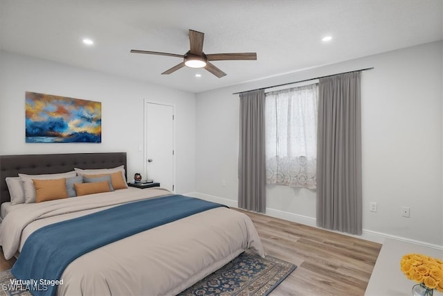 bedroom featuring a ceiling fan, recessed lighting, light wood-style flooring, and baseboards