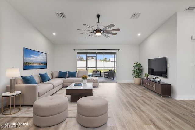 living room featuring baseboards, visible vents, and light wood-style floors