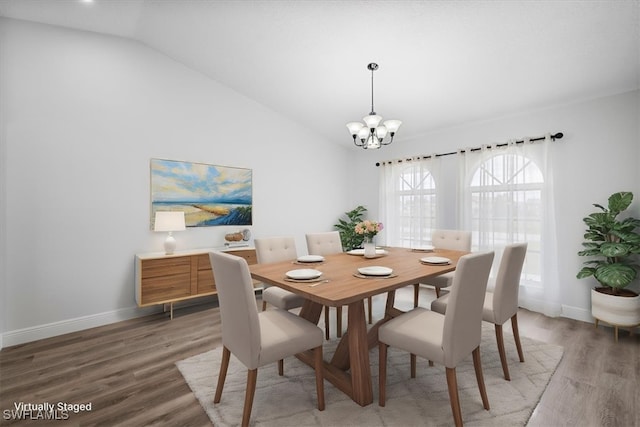 dining space with an inviting chandelier, baseboards, vaulted ceiling, and wood finished floors