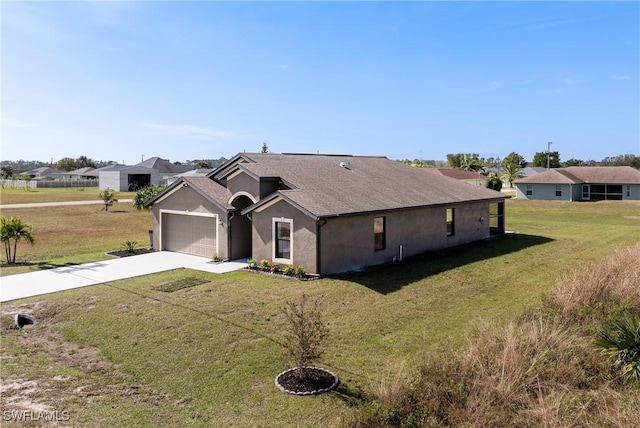 ranch-style home featuring a garage and a front yard