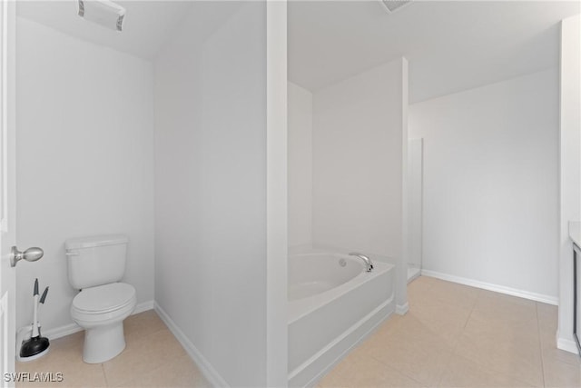 bathroom with vanity, toilet, tile patterned flooring, and a washtub