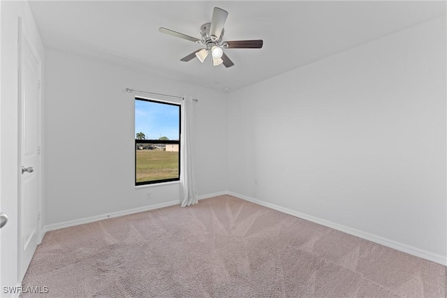 carpeted empty room featuring ceiling fan