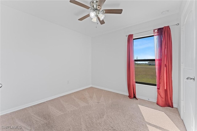 empty room featuring light colored carpet and ceiling fan