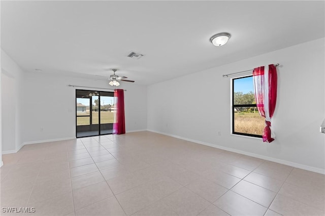 empty room with light tile patterned flooring and ceiling fan