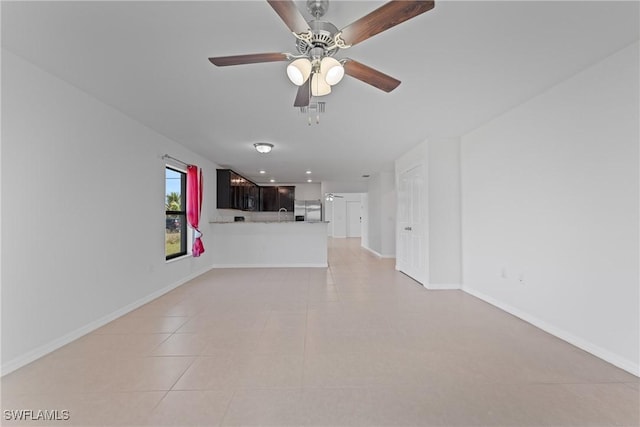 unfurnished living room with ceiling fan and light tile patterned floors