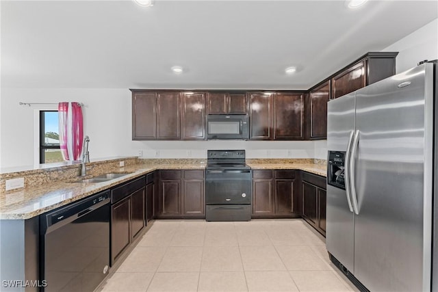 kitchen featuring black appliances, sink, light tile patterned floors, dark brown cabinetry, and light stone counters