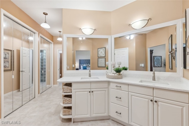 full bathroom featuring double vanity, ensuite bath, and a sink