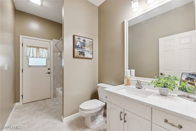 bathroom featuring bathing tub / shower combination, toilet, vanity, tile patterned flooring, and baseboards