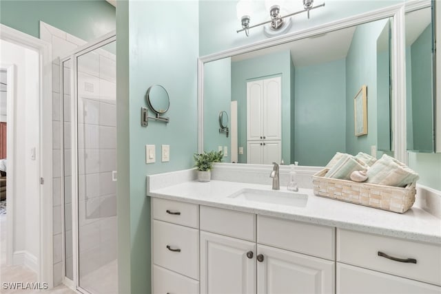 full bath featuring a stall shower and vanity