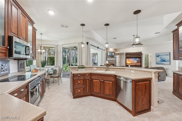 kitchen featuring open floor plan, light countertops, visible vents, and stainless steel appliances