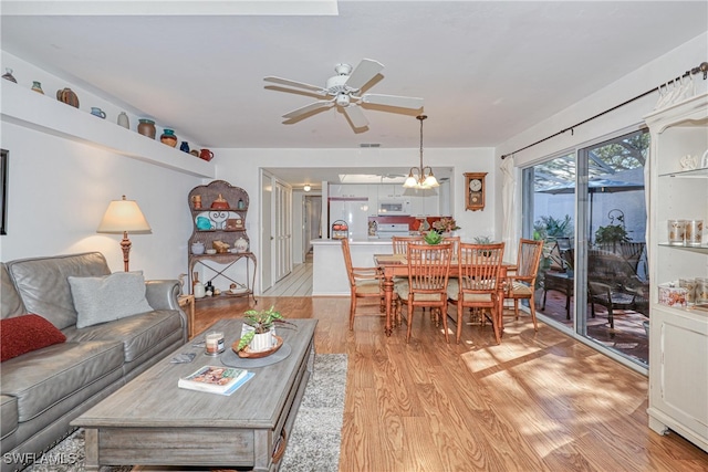 living room with ceiling fan and light hardwood / wood-style floors