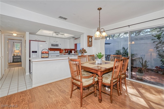 dining area featuring a wealth of natural light and light hardwood / wood-style flooring