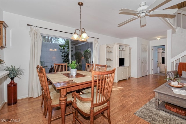 dining room with ceiling fan and light hardwood / wood-style floors