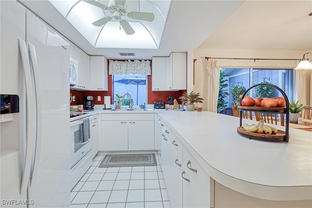 kitchen with white cabinetry, sink, light tile patterned floors, kitchen peninsula, and white appliances