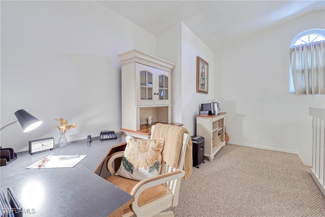 carpeted office space featuring vaulted ceiling