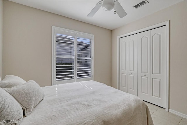 tiled bedroom with a closet and ceiling fan