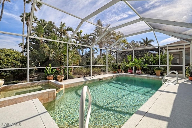 view of pool featuring an in ground hot tub, a lanai, and a patio area