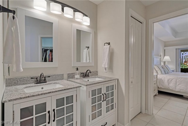 bathroom with tile patterned floors and vanity