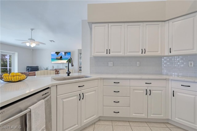 kitchen featuring white cabinetry, sink, stainless steel dishwasher, and backsplash