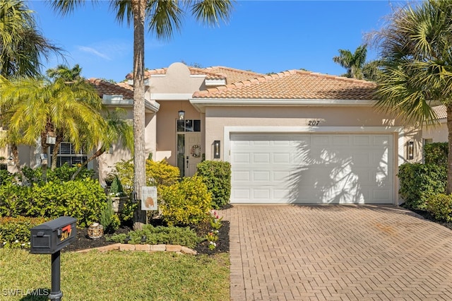 mediterranean / spanish-style home with a garage