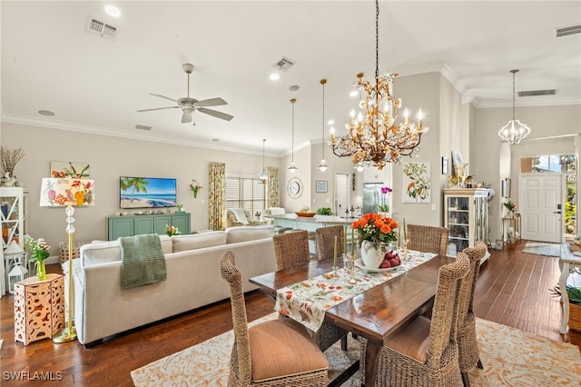 dining room with ornamental molding, dark hardwood / wood-style floors, and ceiling fan with notable chandelier