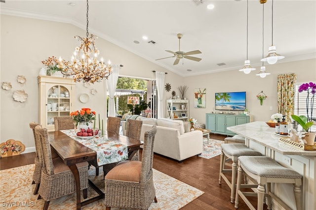 dining space featuring dark wood-type flooring, ornamental molding, lofted ceiling, and ceiling fan