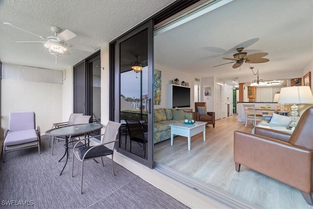 interior space featuring outdoor lounge area and ceiling fan