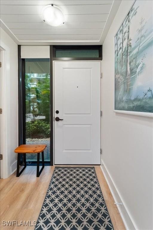 entryway with light hardwood / wood-style flooring and floor to ceiling windows