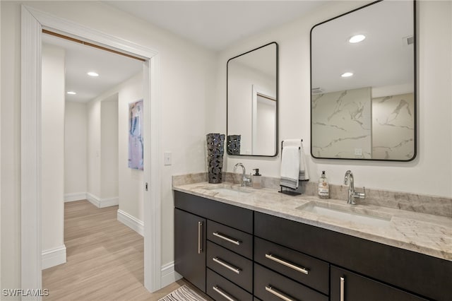 bathroom with vanity and wood-type flooring