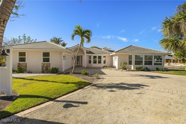 ranch-style home with a front lawn