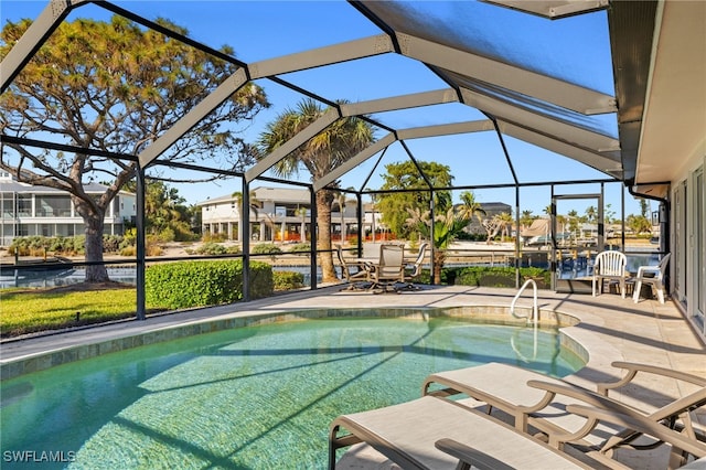 view of swimming pool featuring a lanai and a patio area