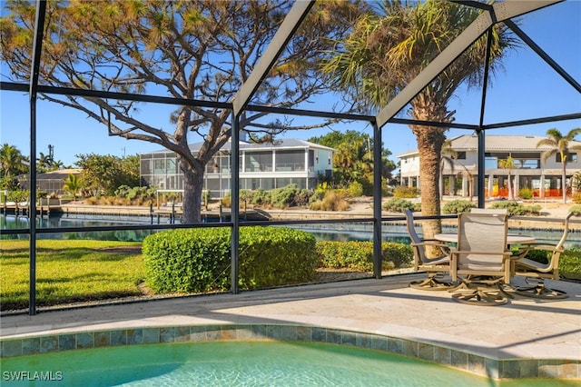 view of pool with a patio area and glass enclosure