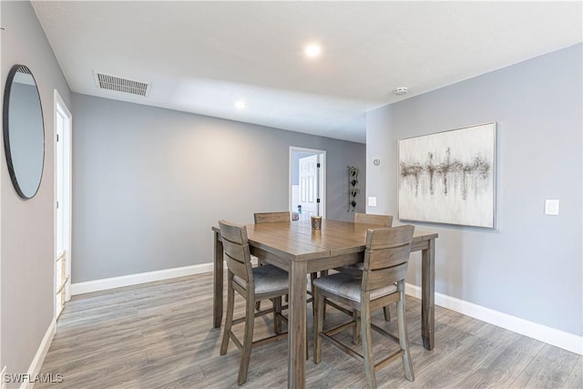 dining area with hardwood / wood-style floors