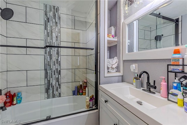 bathroom featuring vanity and combined bath / shower with glass door