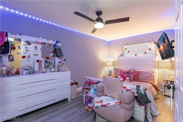 bedroom featuring hardwood / wood-style flooring and ceiling fan