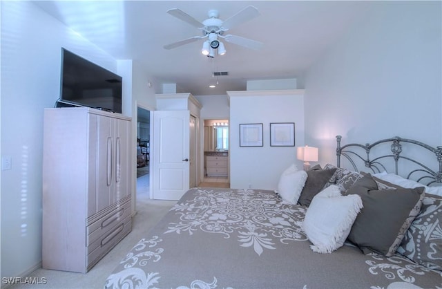 carpeted bedroom with ceiling fan and ensuite bathroom