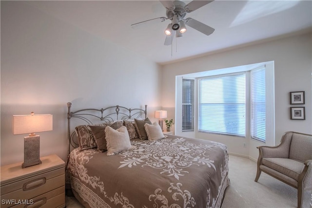 bedroom with ceiling fan and light colored carpet