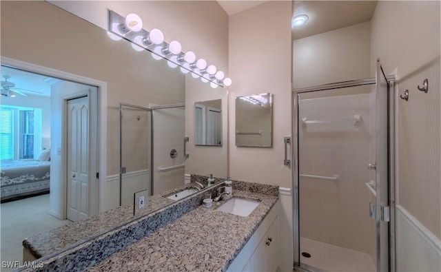 bathroom featuring vanity, ceiling fan, and a shower with shower door