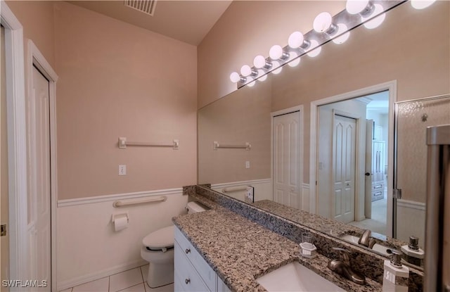 bathroom with vanity, toilet, and tile patterned flooring